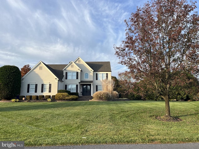 front facade with a front yard