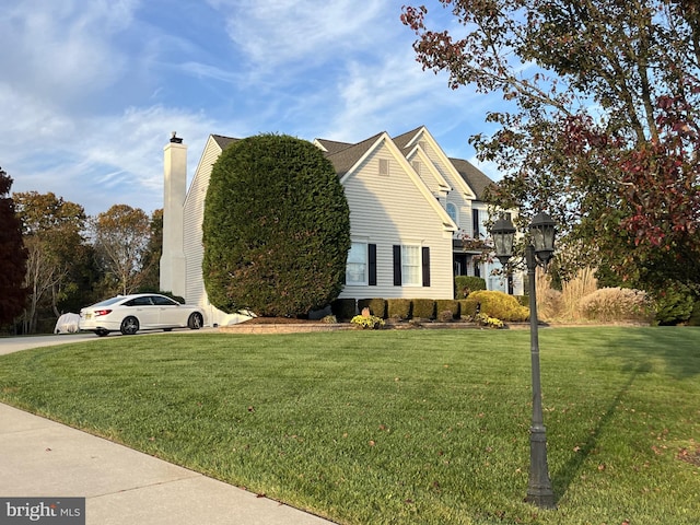 view of side of home with a lawn