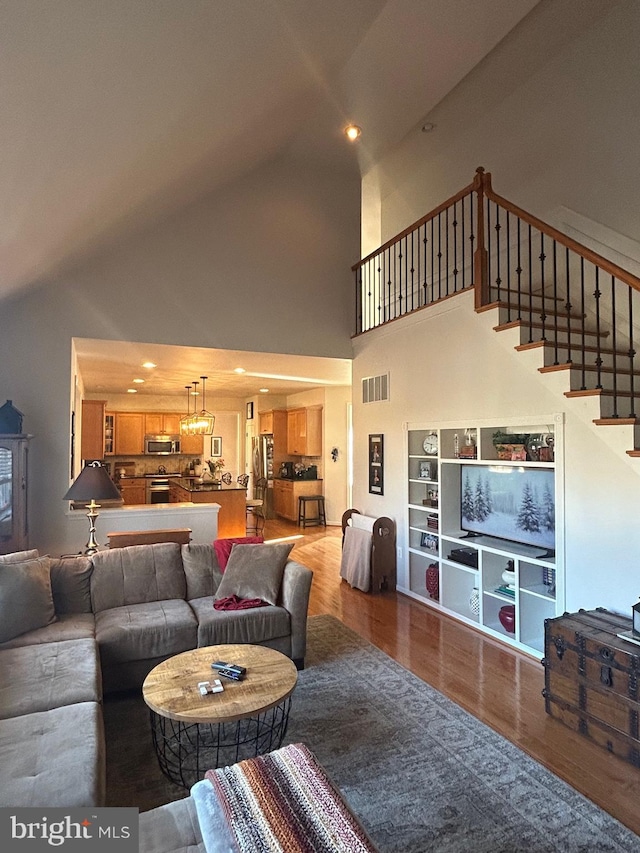 living room featuring hardwood / wood-style flooring and vaulted ceiling