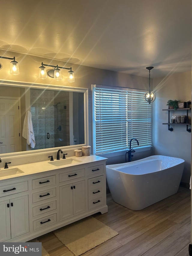 bathroom with vanity, wood-type flooring, and separate shower and tub