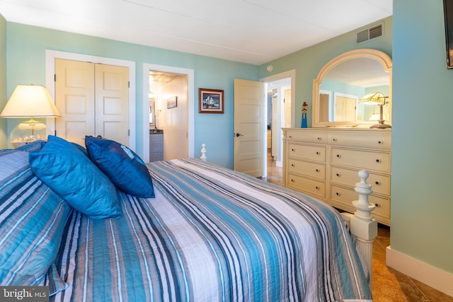 bedroom with ensuite bath and a closet