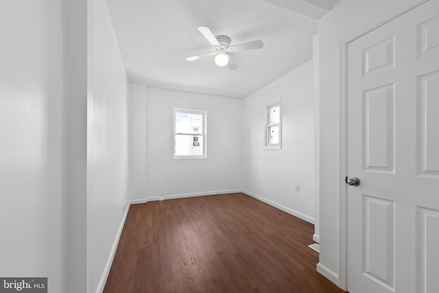 empty room featuring dark wood-type flooring and ceiling fan