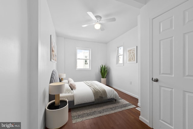 bedroom with dark hardwood / wood-style floors and ceiling fan