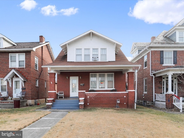 view of front of home with a front yard and covered porch