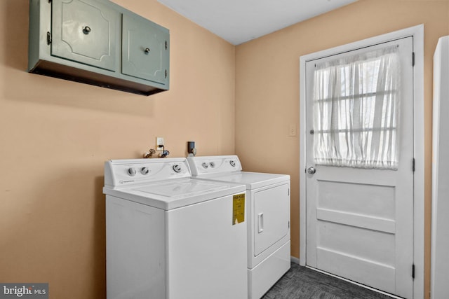 washroom with cabinets and washer and clothes dryer