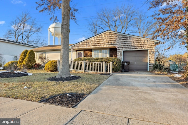 ranch-style house featuring a garage and a front yard