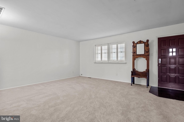 view of carpeted foyer entrance