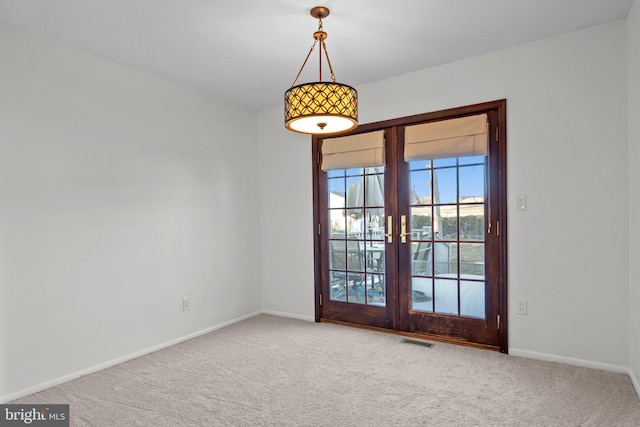 carpeted empty room with french doors