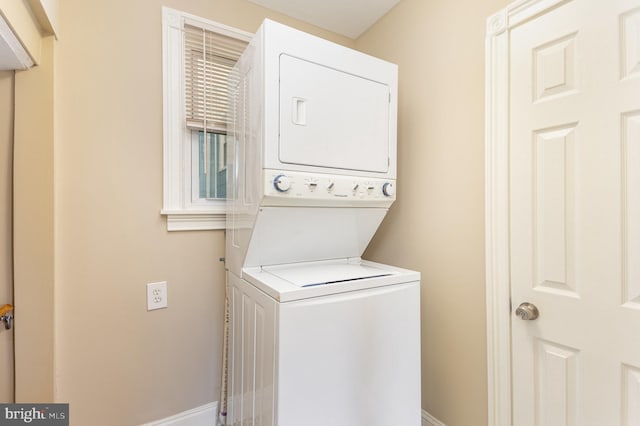 laundry room with stacked washer / drying machine