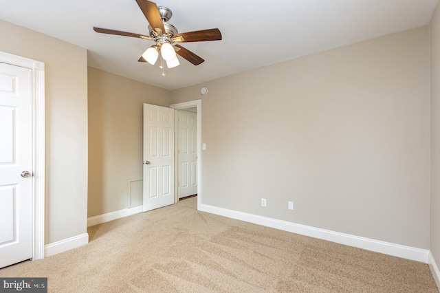 unfurnished bedroom featuring light colored carpet and ceiling fan