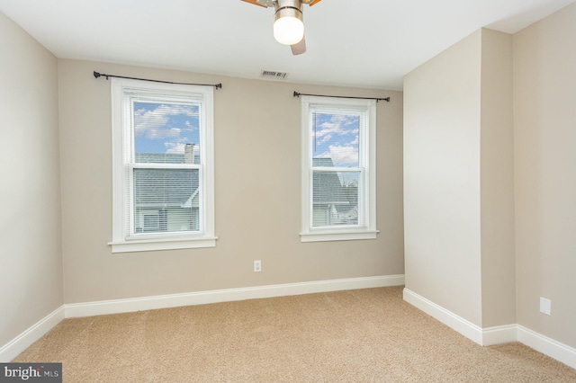 spare room with carpet floors and ceiling fan