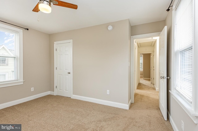 unfurnished bedroom with light carpet and ceiling fan