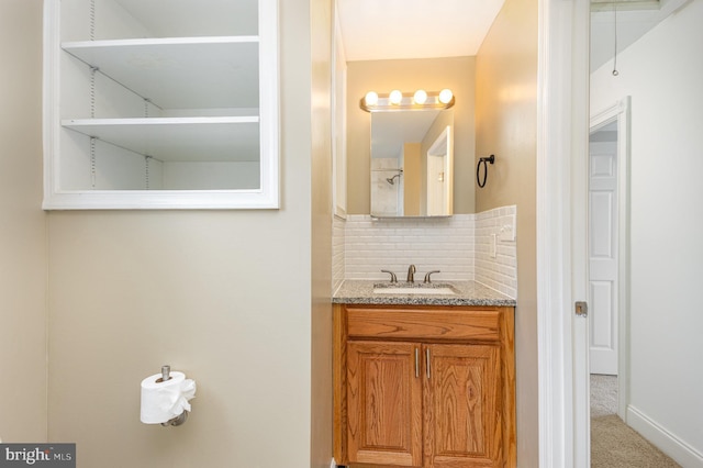 bathroom featuring vanity and decorative backsplash