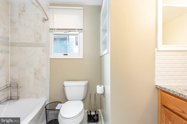 full bathroom with tiled shower / bath, vanity, and toilet