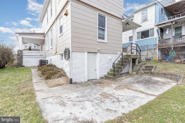 rear view of house featuring a patio and a yard