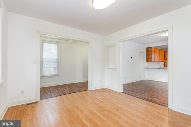 spare room with light hardwood / wood-style flooring