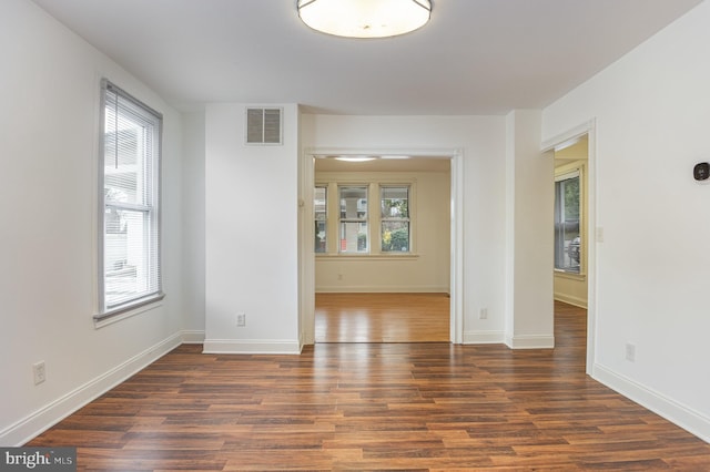 unfurnished room featuring dark hardwood / wood-style flooring