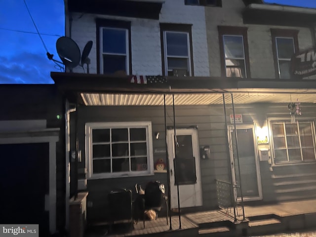 rear view of house featuring a porch