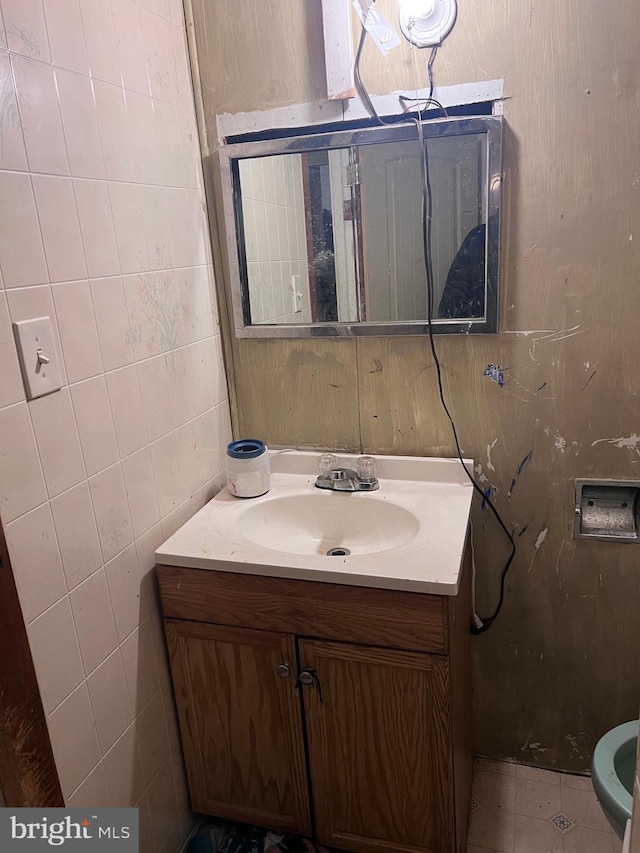 bathroom featuring tile patterned flooring, vanity, and tile walls