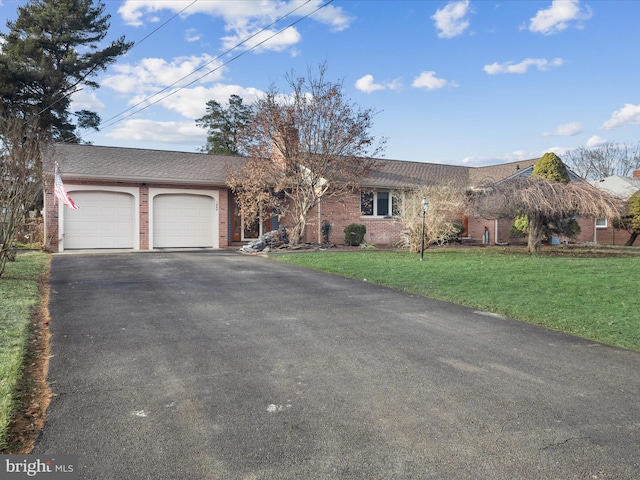 ranch-style home featuring a garage and a front yard