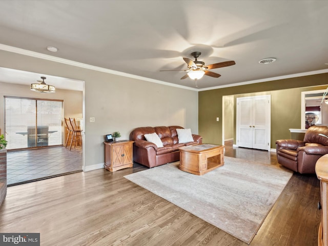 living room with crown molding, hardwood / wood-style flooring, and ceiling fan