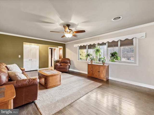 living room with crown molding, ceiling fan, and wood-type flooring