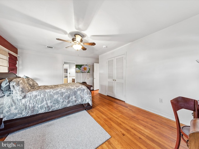 bedroom with ceiling fan, hardwood / wood-style floors, and a closet