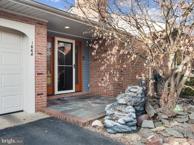 view of exterior entry with a garage