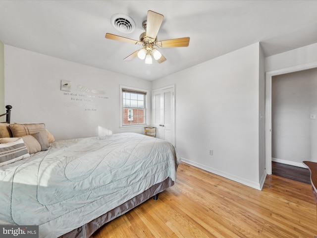 bedroom with light hardwood / wood-style floors, a closet, and ceiling fan