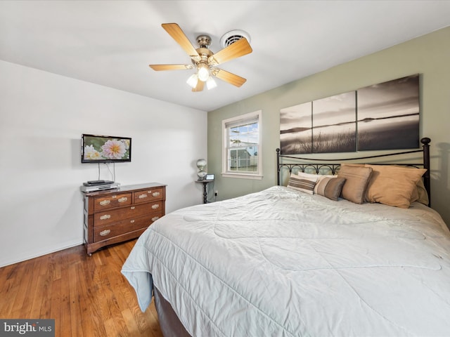 bedroom with hardwood / wood-style flooring and ceiling fan