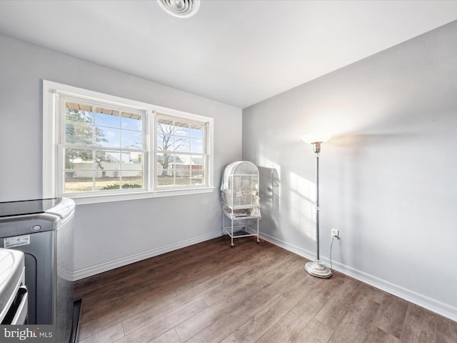 washroom with wood-type flooring and washer / dryer