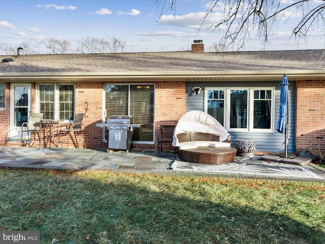 rear view of house featuring a patio and a lawn