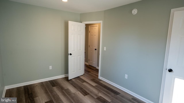 unfurnished bedroom featuring dark hardwood / wood-style floors