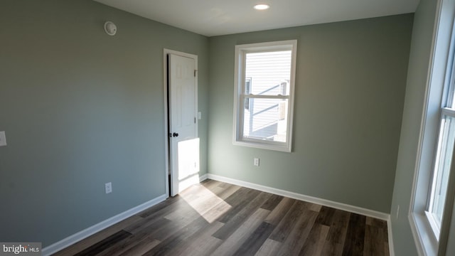 spare room featuring dark hardwood / wood-style flooring