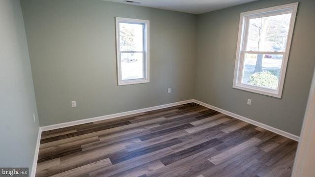 spare room featuring dark hardwood / wood-style floors