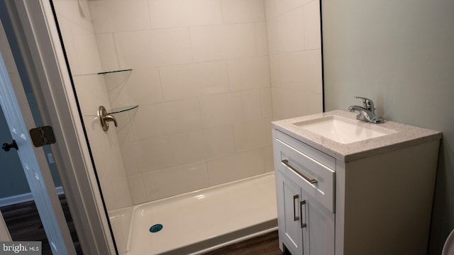 bathroom featuring vanity and tiled shower