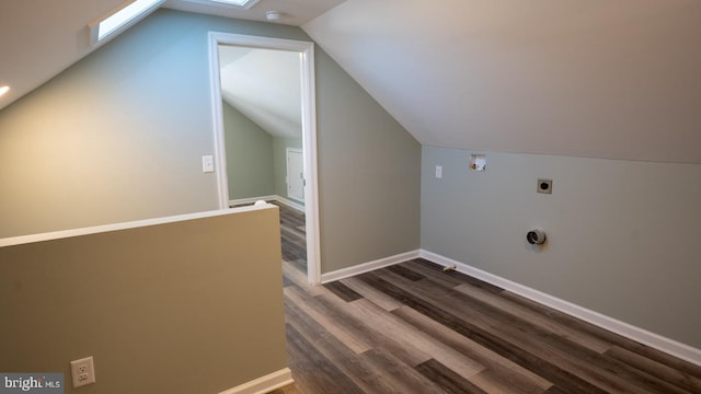 additional living space with lofted ceiling and hardwood / wood-style flooring