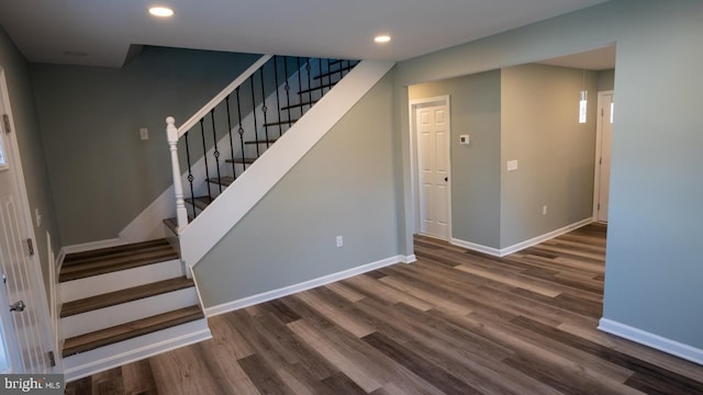 staircase with hardwood / wood-style floors