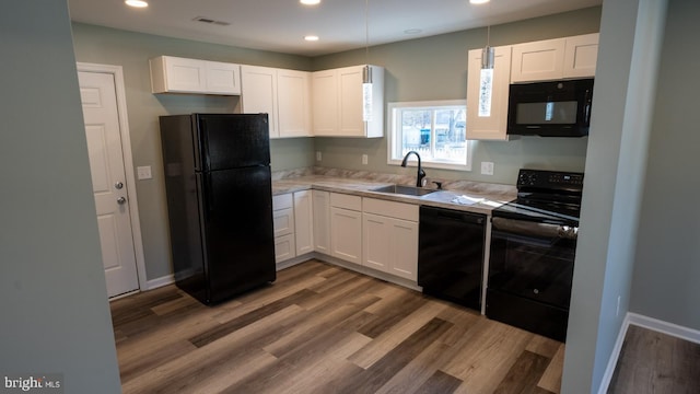 kitchen with white cabinetry, sink, black appliances, and dark hardwood / wood-style floors