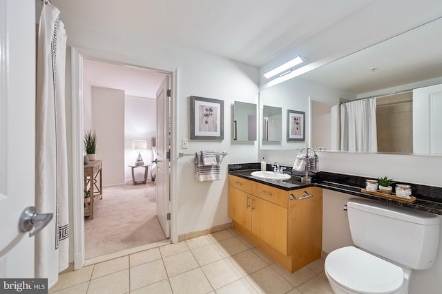 bathroom featuring a shower with curtain, tile patterned floors, toilet, and vanity