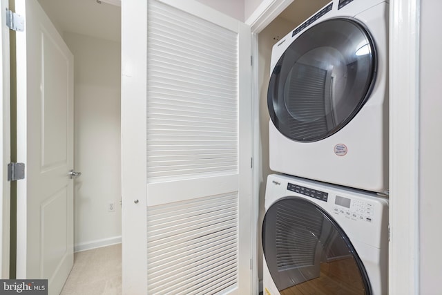 washroom with stacked washer and clothes dryer