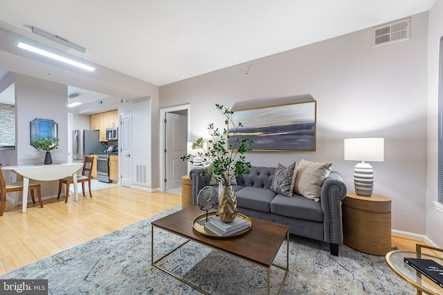 living room with light hardwood / wood-style flooring