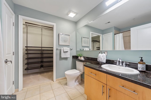 bathroom featuring tile patterned flooring, vanity, and toilet