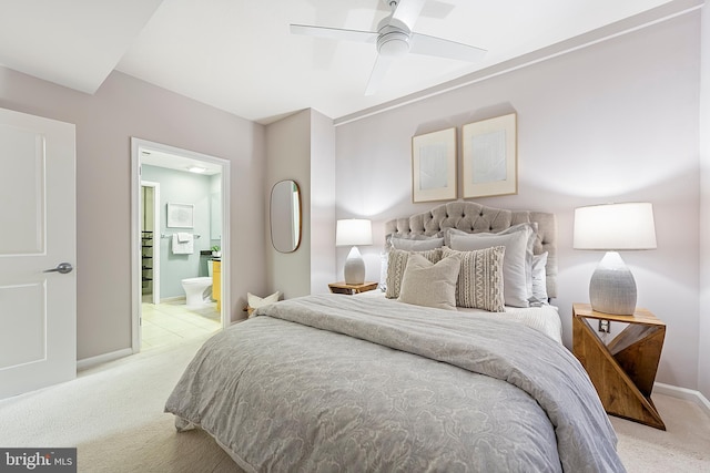 bedroom with light carpet, connected bathroom, and ceiling fan