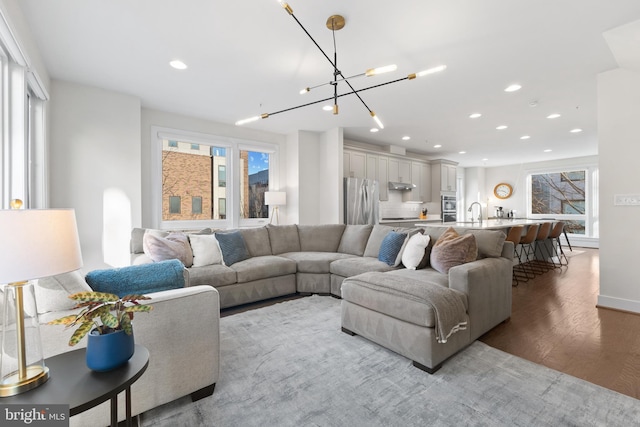 living room with wood finished floors and recessed lighting