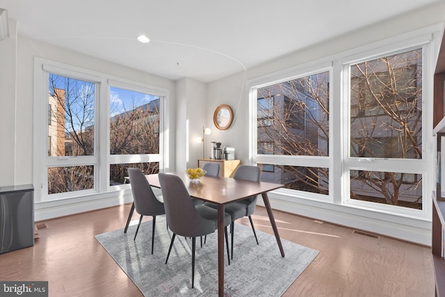 dining area with wood finished floors and visible vents