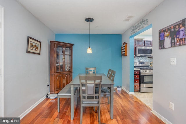 dining room with wood-type flooring