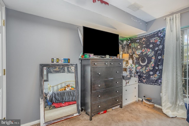 bedroom featuring light colored carpet