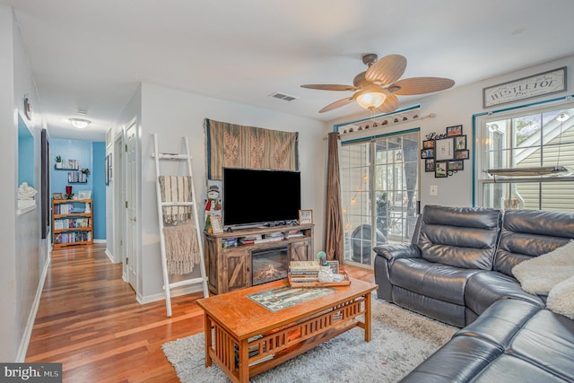 living room with hardwood / wood-style floors and ceiling fan