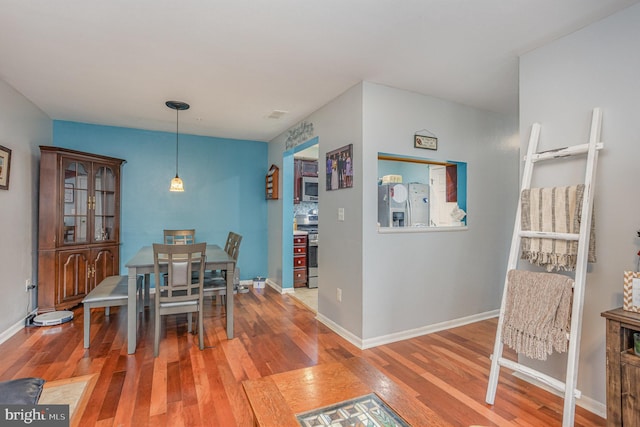 dining space with hardwood / wood-style floors